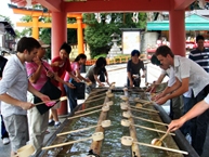 Participants purifying their hands before entering Fushimi Inari Shrine