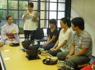 A picture of the participants receiving explanation of the tea-making utensils