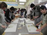 The students trying their hand at making kamaboko
