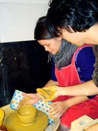 Participant receiving guidance at Pottery School