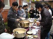 Participants tasting vegetable soup (ozoni), and sweet alcohol (amazake)