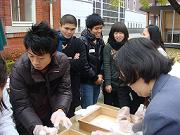 Participants dividing mochi into small pieces